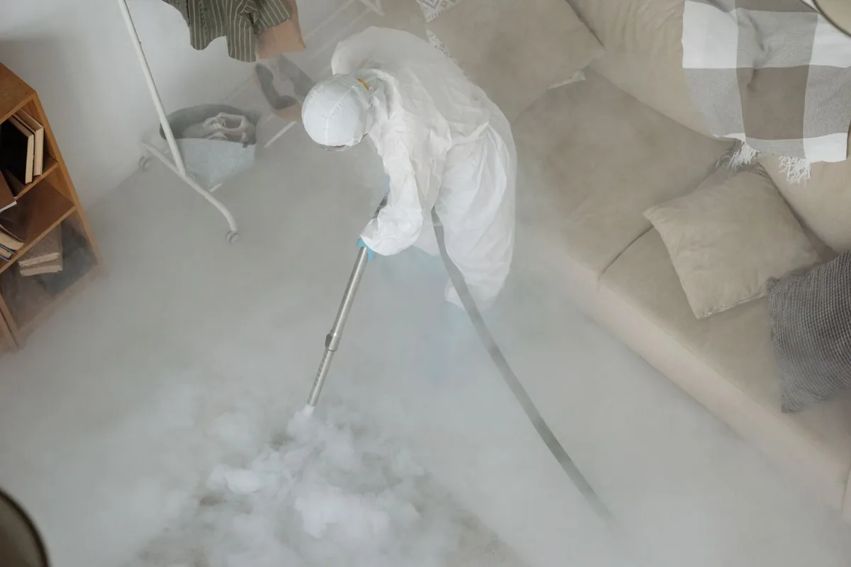 Biohazard cleanup technician in protective equipment, Rollingwood, CA